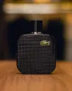 Estilo não se veste apenas. Se sente.O L.12.12 Noir da Lacoste traduz a essência do homem elegante, intenso e seguro de si. Um perfume noturno, envolvente e inesquecível.  Garanta o seu na Villa Storeman..webp